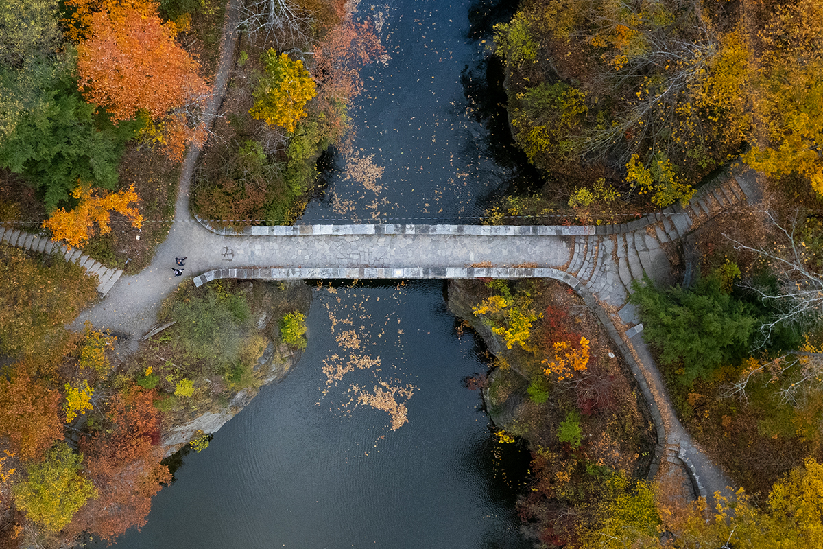 Aerial view of a river and bridge in autumn.