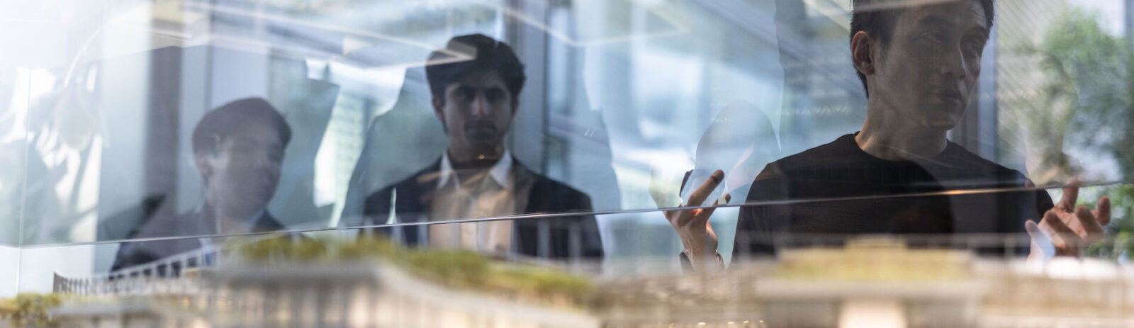 Three students looking at a architectural model
