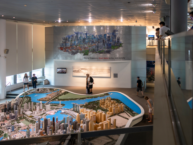 Cornell real estate students walking through an indoor model of Singapore.