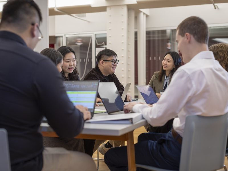 Group of Cornell real estate students working in NYC offices on group project.