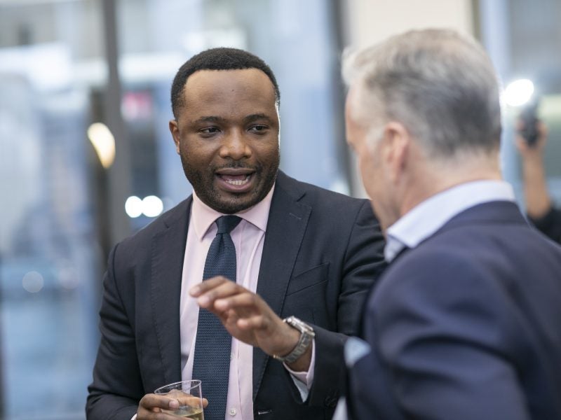 MPS Real Estate student engaging with industry professionals after lecture event.