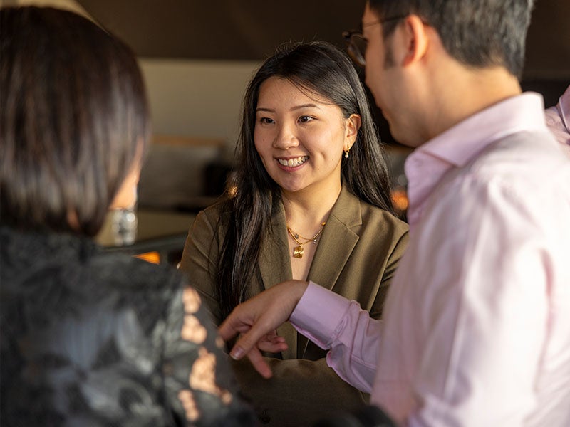 A group of alumni networking during an event.